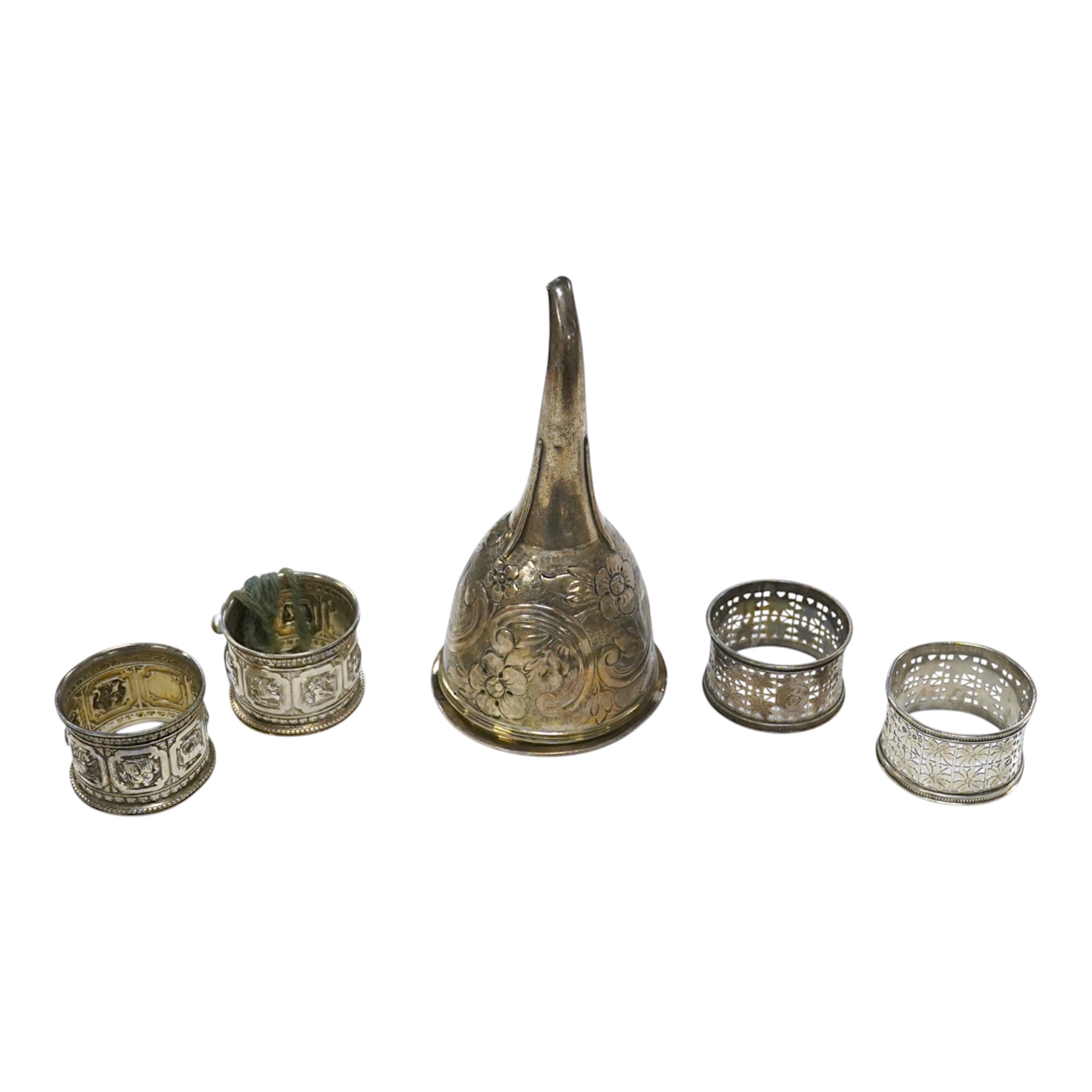 Two pairs of Victorian silver napkin rings and a George III silver wine funnel with later embossed decoration, 14.1cm. Condition - poor to fair